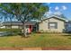 Charming single-story home featuring a bright red front door and lush green lawn at 230 S Ranger Blvd, Winter Park, FL 32792