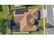 An aerial shot of the house showing the solar panels and screened-in pool at 2509 Chapala Dr, Kissimmee, FL 34746