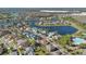 Beautiful aerial view of a Primary-planned community featuring mature landscaping, serene lakes, and a resort-style pool at 2509 Chapala Dr, Kissimmee, FL 34746