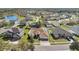 Aerial view of a home in a neighborhood with a lake and green spaces at 2509 Chapala Dr, Kissimmee, FL 34746