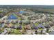 Beautiful aerial view of a residential neighborhood with mature trees, green lawns, and serene ponds at 2509 Chapala Dr, Kissimmee, FL 34746