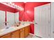 Bathroom featuring dual sinks, a large mirror with Hollywood lights, and ample counter space at 2509 Chapala Dr, Kissimmee, FL 34746