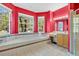 Bright bathroom featuring a large soaking tub, red walls, and multiple windows offering outdoor views at 2509 Chapala Dr, Kissimmee, FL 34746