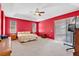 Spacious main bedroom featuring carpet floors, a ceiling fan, and sliding glass doors at 2509 Chapala Dr, Kissimmee, FL 34746