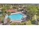 Relaxing pool with poolside lounge chairs, lush trees and nearby community clubhouse at 2509 Chapala Dr, Kissimmee, FL 34746