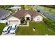 Aerial view of a house with a well-manicured lawn, beautiful landscaping, and a two car garage at 2601 Gold Dust Cir, Kissimmee, FL 34744