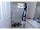 Bathroom with a tub, shower, toilet, sink and a black and white shower curtain at 2601 Gold Dust Cir, Kissimmee, FL 34744