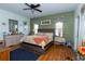 Spacious main bedroom with a ceiling fan, wood floors, and light green accent wall at 2601 Gold Dust Cir, Kissimmee, FL 34744