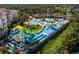 Picturesque aerial view of the community waterpark with slides, pools, and lush greenery at 2774 Almaton Loop # 101, Kissimmee, FL 34747