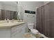 Well-maintained bathroom with a single vanity and shower with curtain at 2774 Almaton Loop # 101, Kissimmee, FL 34747