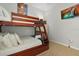 Comfortable bedroom with a wooden bunk bed, TV, soft pillows, and carpeted floor at 2774 Almaton Loop # 101, Kissimmee, FL 34747