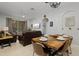 Dining area showcasing a rustic wooden table with seating for six, adjacent to the living room and kitchen at 2774 Almaton Loop # 101, Kissimmee, FL 34747