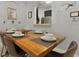 Close-up of dining area with rustic wooden table set for a meal, connecting to a pass through to the kitchen at 2774 Almaton Loop # 101, Kissimmee, FL 34747