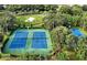 Aerial view of tennis courts and a basketball court surrounded by lush trees in the community at 2774 Almaton Loop # 101, Kissimmee, FL 34747