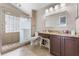 Well-lit bathroom featuring a glass-enclosed shower, neutral tile, and a vanity with a granite countertop at 3043 Autumn Run Ct, Orlando, FL 32822