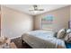 Calm bedroom featuring ceiling fan, wood floors, and a window with natural light at 3043 Autumn Run Ct, Orlando, FL 32822