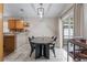 Cozy dining area adjacent to kitchen featuring modern light fixture and easy access to patio at 3043 Autumn Run Ct, Orlando, FL 32822