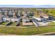 Aerial view of fenced yards with patio, fire pit, and community pool in the background at 3179 Turret Dr, Kissimmee, FL 34743