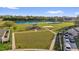 Aerial view of community park featuring playground, basketball court, pond, and plenty of green space at 3179 Turret Dr, Kissimmee, FL 34743