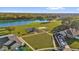 Overhead shot of a community park featuring a playground, basketball court, lake, and green space at 3179 Turret Dr, Kissimmee, FL 34743