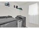 This laundry room features modern washer and dryer with overhead shelving at 3179 Turret Dr, Kissimmee, FL 34743