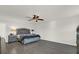 Spacious main bedroom featuring ceiling fan, modern finishes and gray wood floors at 3179 Turret Dr, Kissimmee, FL 34743