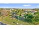 Neighborhood playground featuring playset, swing set, mature trees, and shaded benches at 3179 Turret Dr, Kissimmee, FL 34743