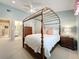 Airy bedroom with a four-poster bed, a ceiling fan, and an en suite bathroom at 3431 Dawn Ct, Lake Mary, FL 32746