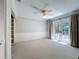 Nice bedroom with neutral walls and an exit to the backyard at 3431 Dawn Ct, Lake Mary, FL 32746