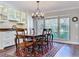 Dining room with a wooden table, elegant chandelier, and built-in cabinets, adjacent to a large window at 3431 Dawn Ct, Lake Mary, FL 32746