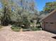 Paver driveway leading to an attached garage, surrounded by mature trees and professionally landscaped flower beds at 3431 Dawn Ct, Lake Mary, FL 32746