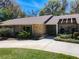 Home exterior featuring stone accents, large windows, and a well-manicured lawn at 3431 Dawn Ct, Lake Mary, FL 32746