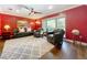 Living room features a dark leather couch, two chairs, a large window and hardwood floors at 3431 Dawn Ct, Lake Mary, FL 32746