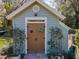 Potting shed with unique decorations, garden trellises, and garden hose at 3431 Dawn Ct, Lake Mary, FL 32746