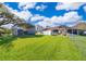 Sprawling backyard with well-maintained lawn, metal carport, and fencing at 372 Rest Haven Rd, Geneva, FL 32732