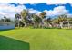 Expansive backyard featuring lush green lawn with mature palm trees at 372 Rest Haven Rd, Geneva, FL 32732