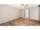 Neutral bedroom with wood-look floors, ceiling fan, and lots of natural light at 372 Rest Haven Rd, Geneva, FL 32732