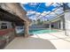 Enclosed pool area featuring a custom grotto, clear blue water, and ample deck space at 372 Rest Haven Rd, Geneva, FL 32732