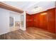 Hardwood floored walk-in closet with wood paneling and overhead light at 372 Rest Haven Rd, Geneva, FL 32732