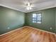 Bedroom with hardwood flooring, window and ceiling fan at 5030 Creekview Ln, Lakeland, FL 33811