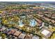 Beautiful aerial view showcasing a resort-style community pool with lush landscaping and neighborhood homes at 5283 Wildwood Way, Davenport, FL 33837