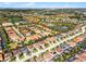 An aerial view of a residential community, featuring a house with a terra cotta roof outlined in red at 5283 Wildwood Way, Davenport, FL 33837