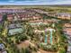 Aerial view featuring a community pool, lazy river, clubhouse, and lush landscaping at 5283 Wildwood Way, Davenport, FL 33837