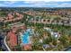 Stunning aerial view showcases a community pool area with palm trees, lounge chairs, and various water features at 5283 Wildwood Way, Davenport, FL 33837