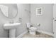 Half bathroom featuring a pedestal sink, modern fixtures, and neutral tile flooring at 5283 Wildwood Way, Davenport, FL 33837