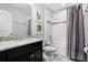 Bathroom featuring a shower-tub combo with modern fixtures and granite countertop vanity at 5283 Wildwood Way, Davenport, FL 33837