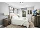 Inviting bedroom featuring neutral colors, a textured headboard, and warm lighting at 5283 Wildwood Way, Davenport, FL 33837