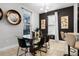 Modern dining room featuring a glass table, black chairs, and an attractive decorative mirror enhancing the space at 5283 Wildwood Way, Davenport, FL 33837