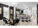 Modern kitchen and dining area with bar seating and stainless steel appliances at 5283 Wildwood Way, Davenport, FL 33837