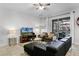 Bright living room with modern furniture, tile flooring, and ample natural light at 5283 Wildwood Way, Davenport, FL 33837